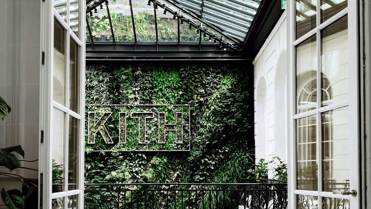 kith logo across greenery wall