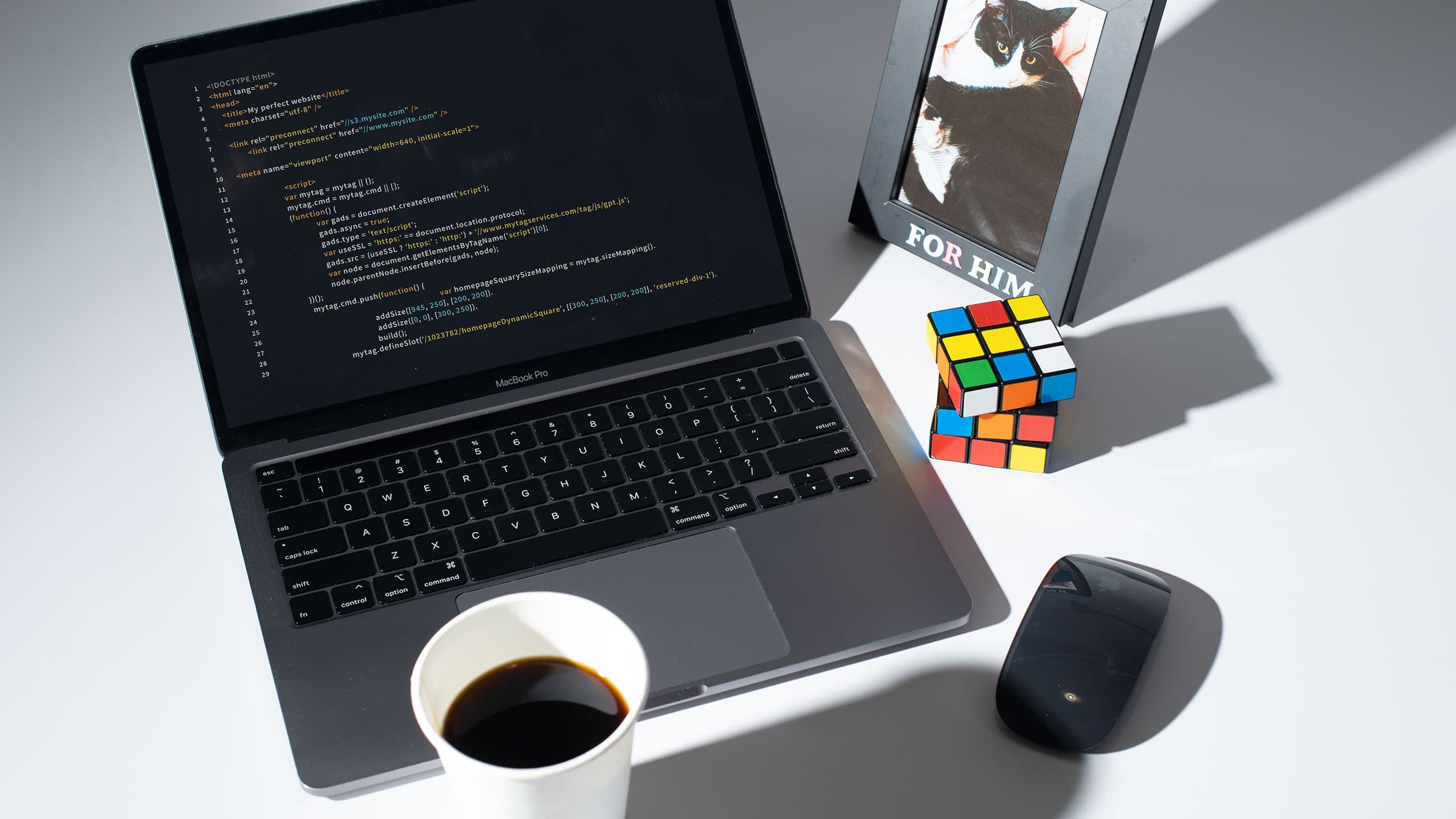 laptop with coding at desk